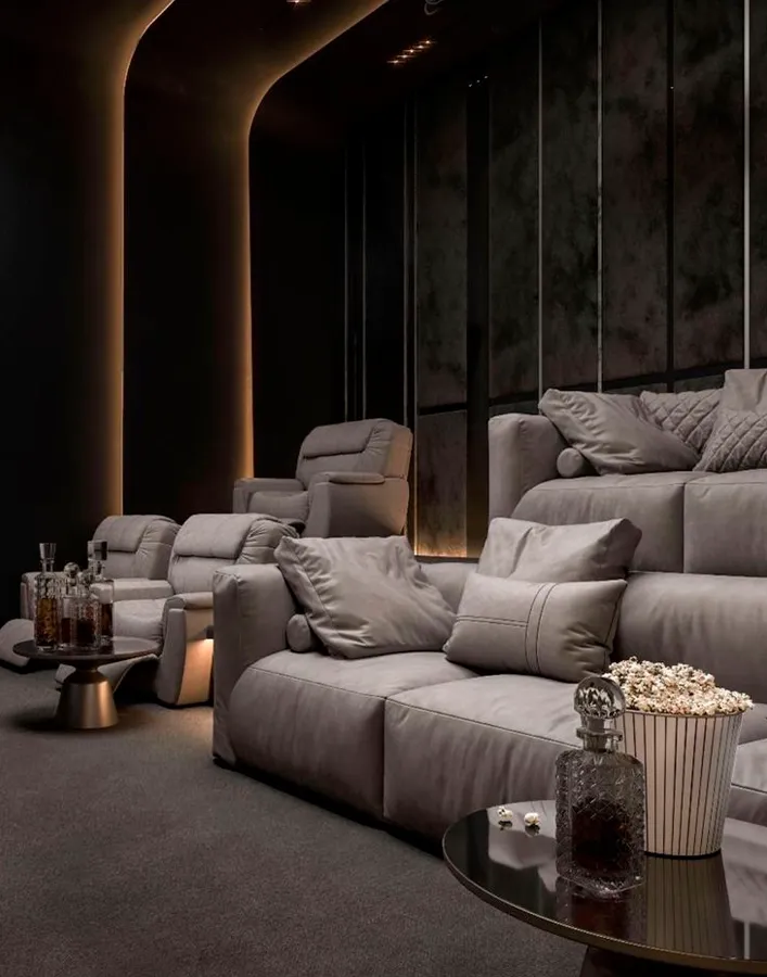 Rustic home theater with exposed beams and sculptural seating